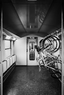 grayscale photo of bikes on rack