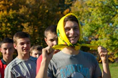 A group of energetic youths wearing saffron scarves, planting trees in a community park.