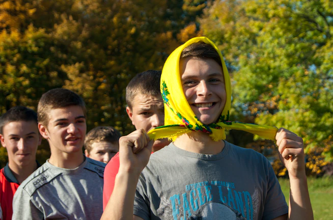 A group of young people smiling during a vocational training workshop outdoors.