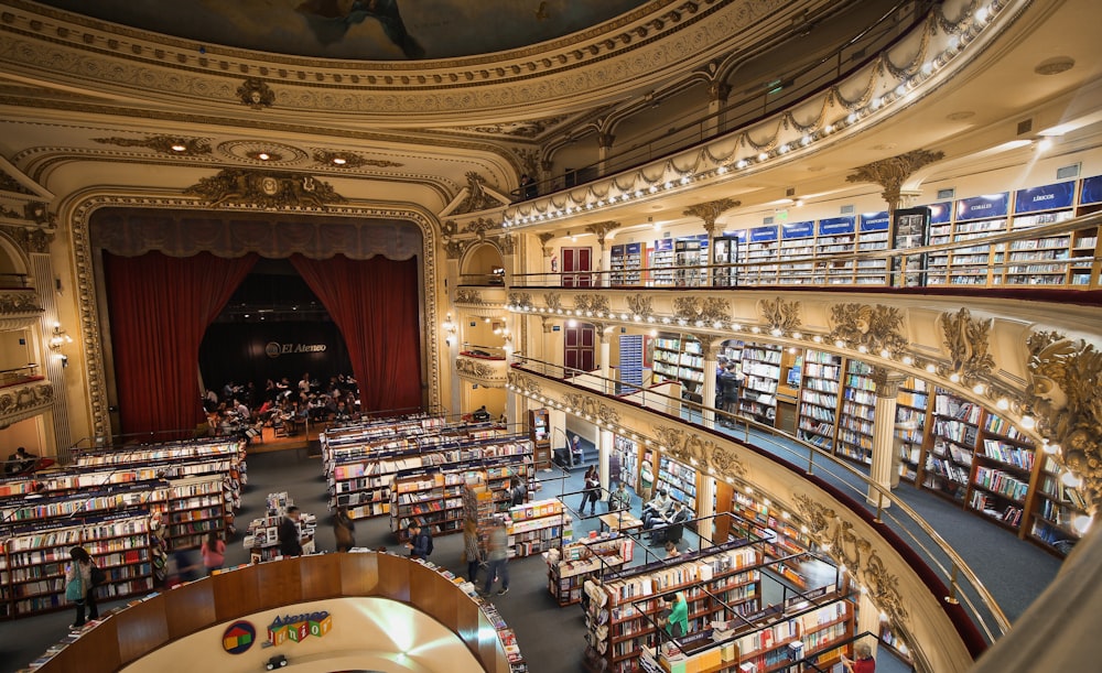 high-angle photo of people inside library with mini stage on room's corner