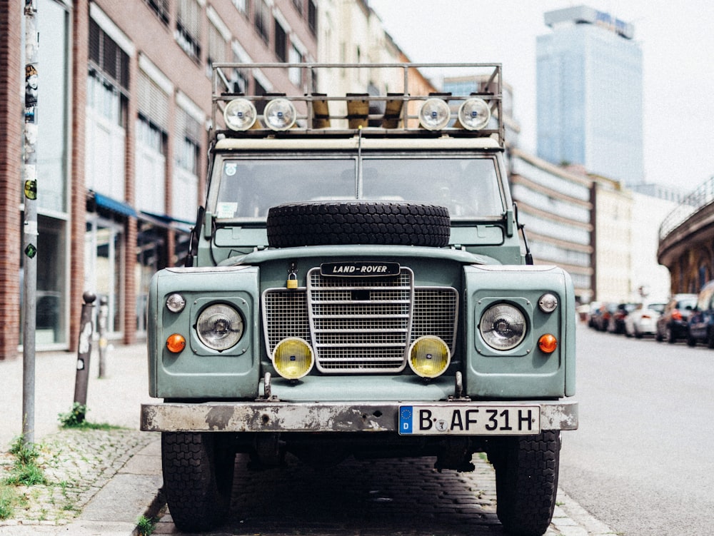 teal and gray vehicle near brown pavement