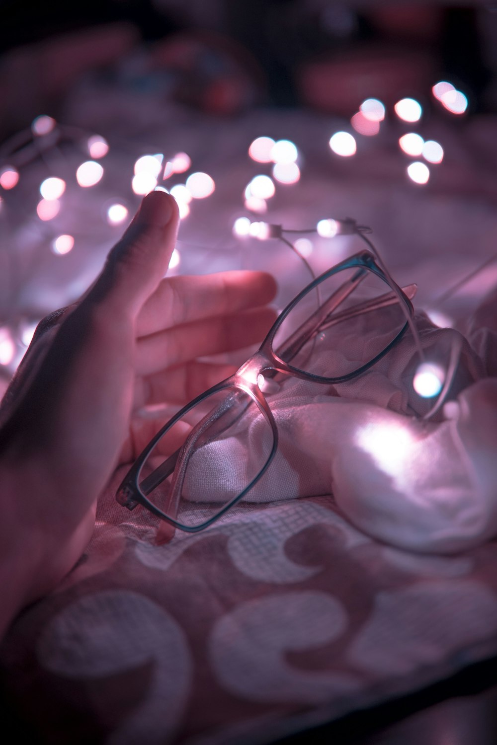 person holding black framed eyeglasses