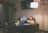 Man thoughtfully reading reviews on a laptop in a cozy room
