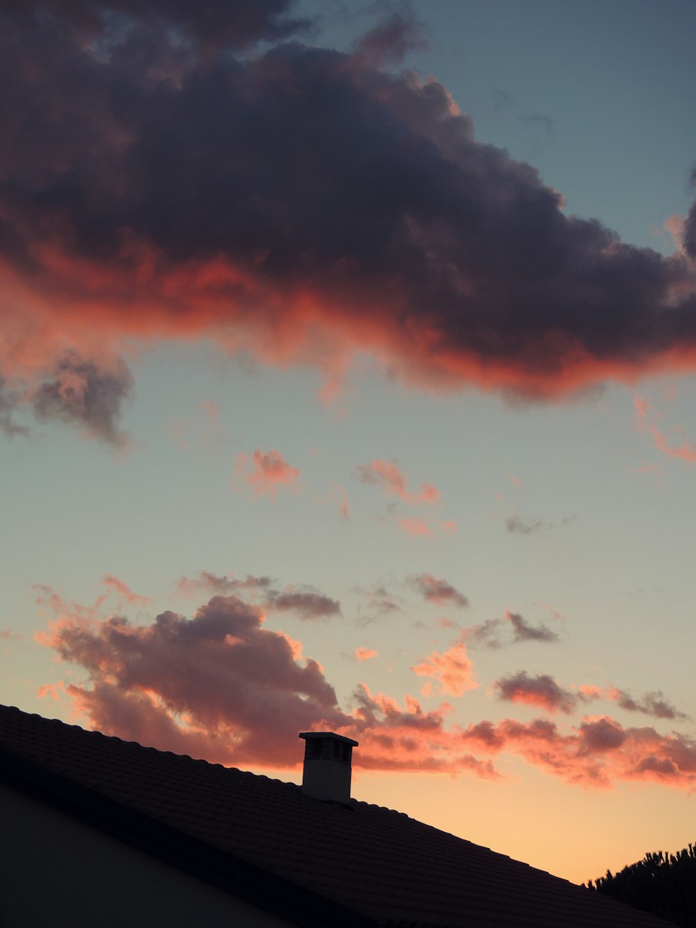 silhouette of chimney under clouds
