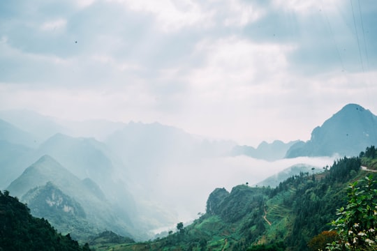 photography of mountains with fog during daytime in Thành phố Hà Giang Vietnam
