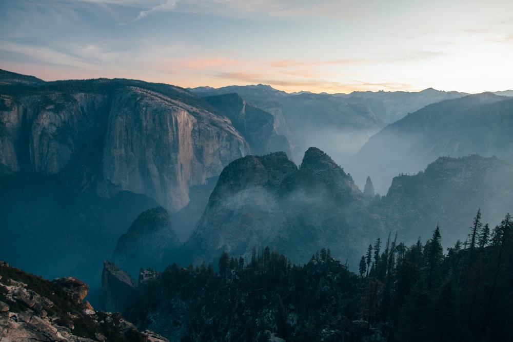 mountain covered with fog during daytime