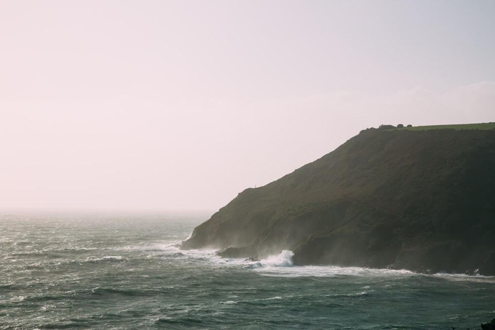 a large body of water next to a cliff