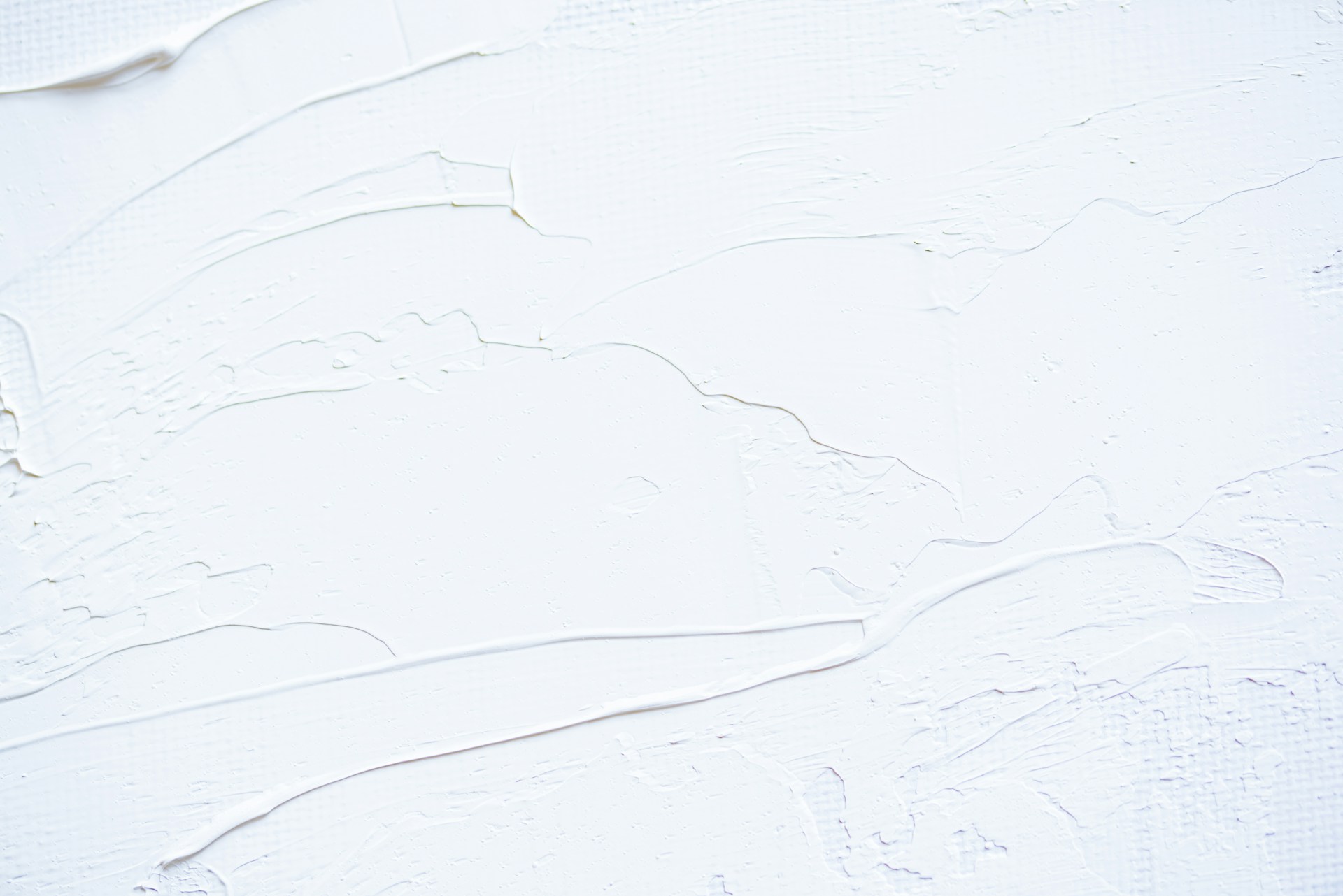 a close up of a white wall with peeling paint