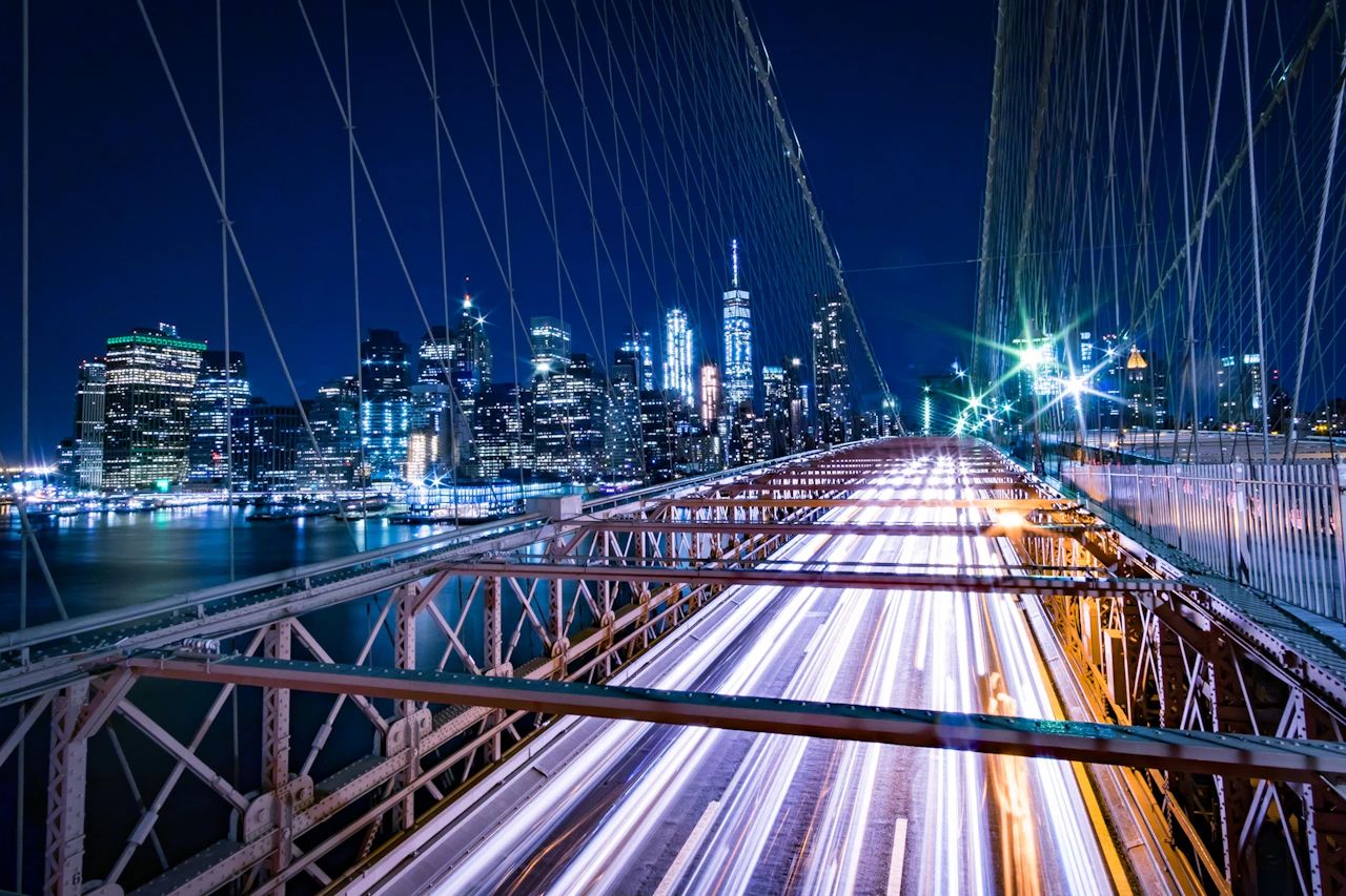 Brooklyn Bridge with traffic light trails at night