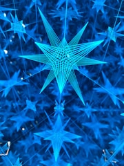 Interconnected star systems representing operational networks in deep indigo and metallic gold.