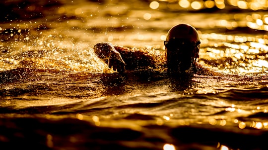 person swimming on body of water at nighttime in Venise-en-Québec Canada