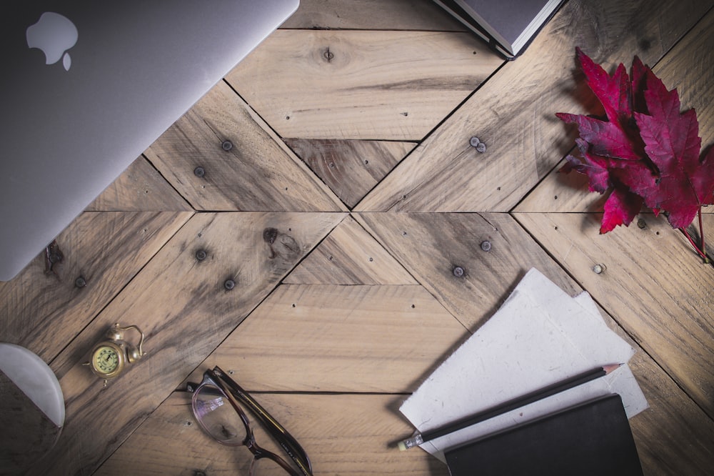 clear eyeglasses with black frames on brown parquet floor