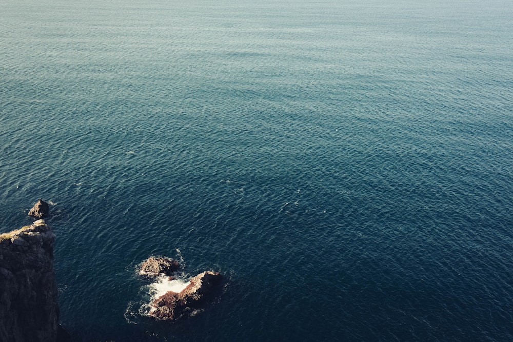 a large body of water sitting next to a cliff