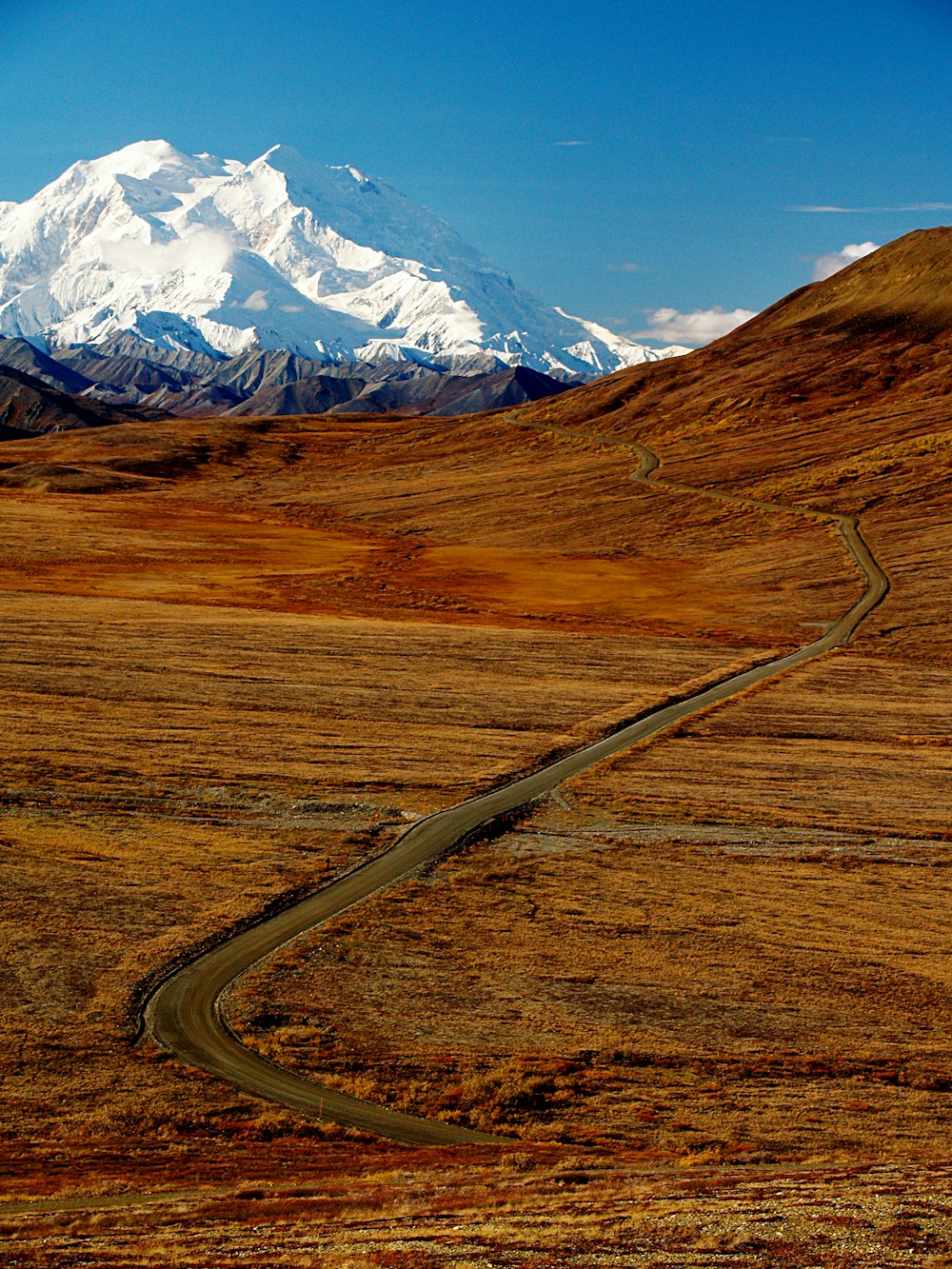 plains near mountain under blue sky