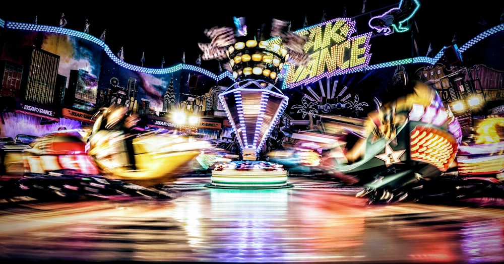 a group of people riding on top of a carnival ride