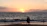 A happy couple enjoying a sunset beach walk during their honeymoon trip.