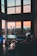 Elegant living room with panoramic views of the estate at sunset.