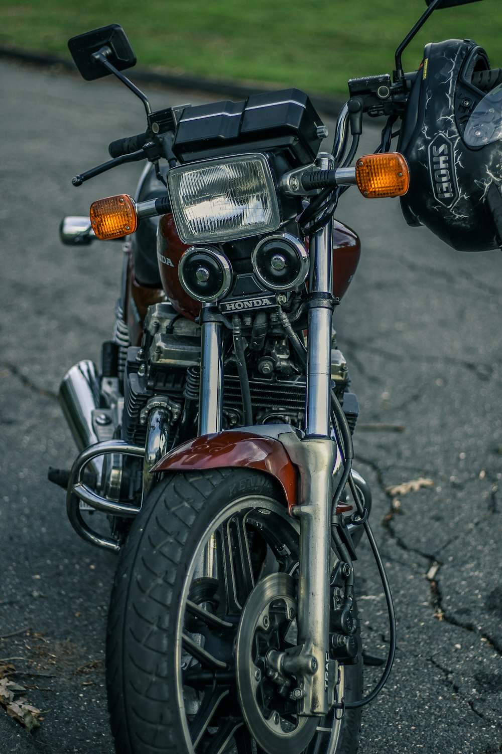 black and red Honda motorcycle on black concrete pavement