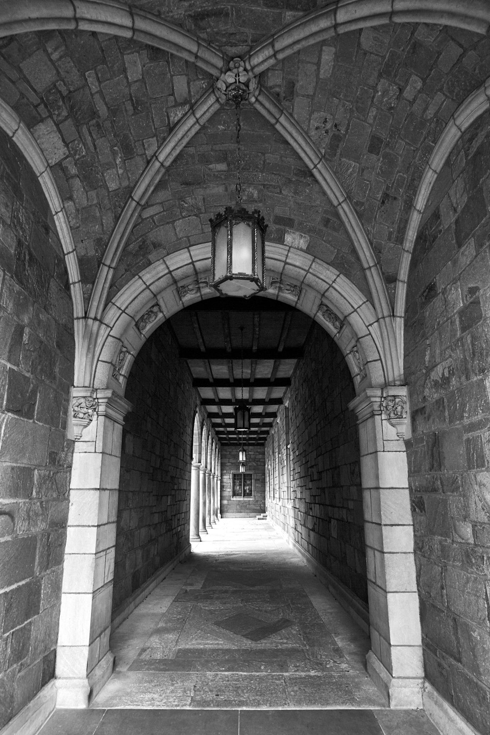 grayscale photography of an arc hallway