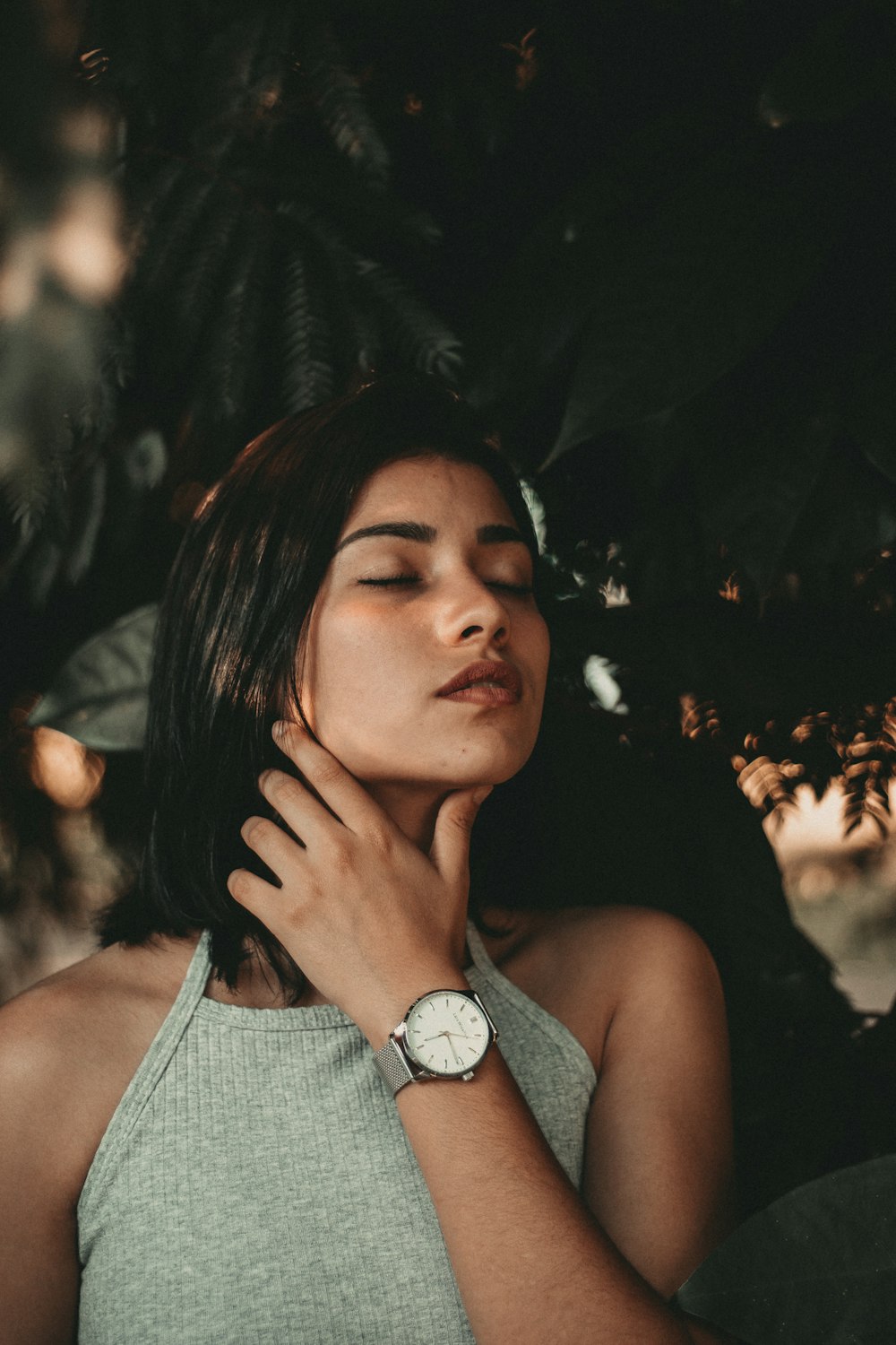 selective focus photo of woman in gray sleeveless top