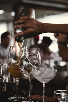Close-up of hands expertly shaking a cocktail shaker with ice