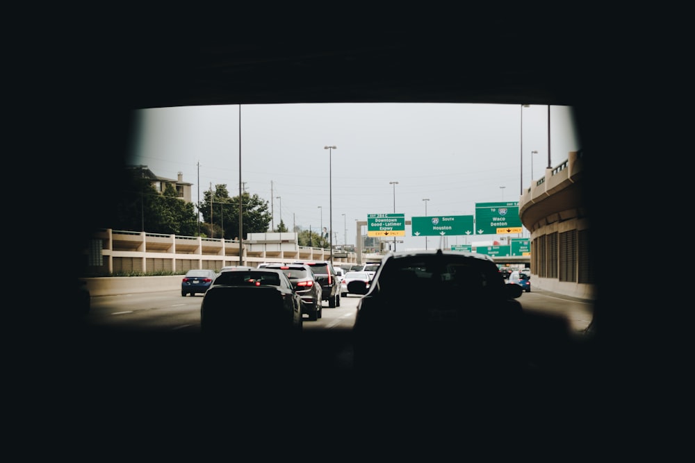 vehicles on wide concrete road during daytime