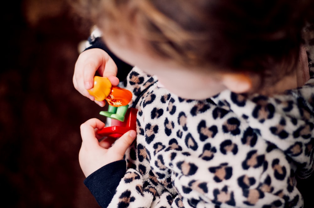 girl holding plastic toys in macro photography