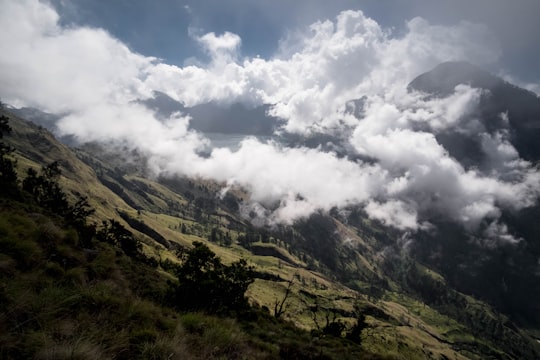 green mountain under cloudy sky in Mount Rinjani Indonesia