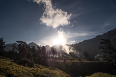 A serene landscape with a sunrise illuminating a quiet valley.