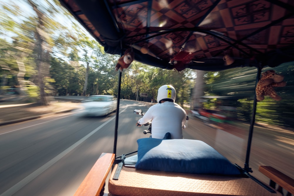 man riding auto rickshaw during daytime