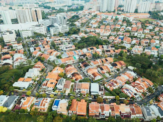 aerial photography of villages near high-rise buildings during daytime