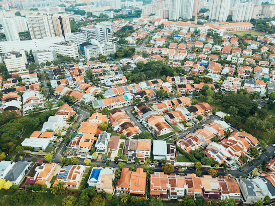 aerial photography of villages near high-rise buildings during daytime