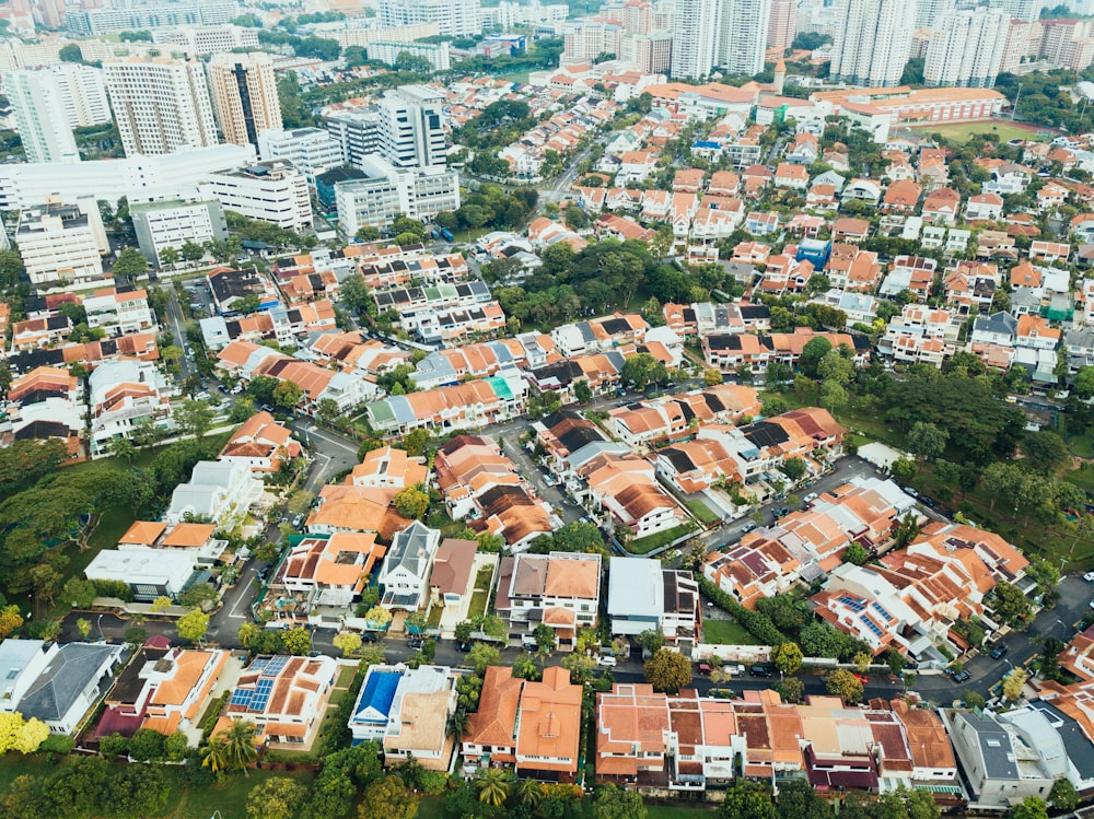 aerial photography of villages near high-rise buildings during daytime