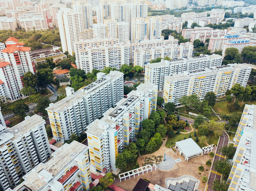 aerial photo of white concrete buildings near green leaf trees