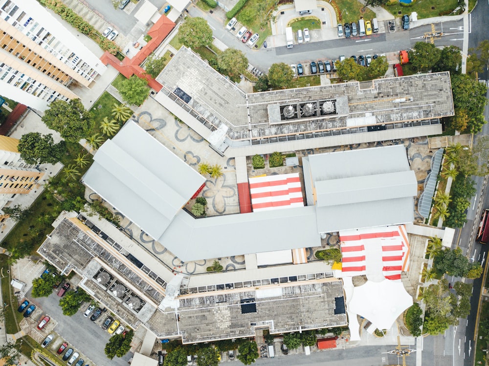 top view photography of buildings beside road and trees at daytime