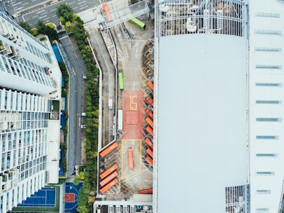 bird's-eye view photography of high-rise building beside asphalt road
