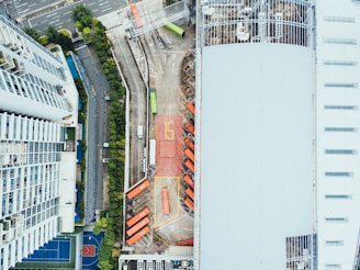 bird's-eye view photography of high-rise building beside asphalt road