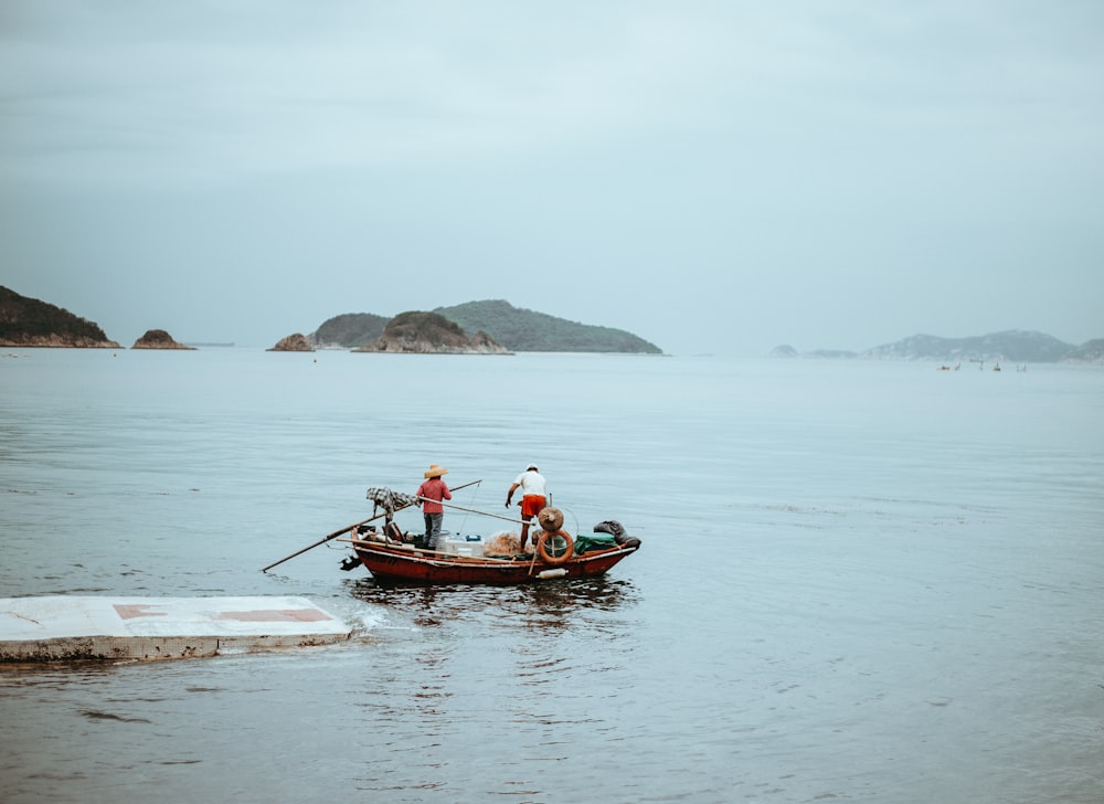 two person riding on brown boat