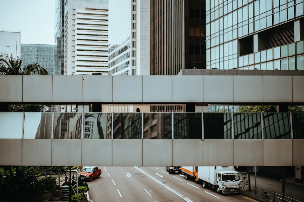 white and gray building besides parked vehicle at daytime