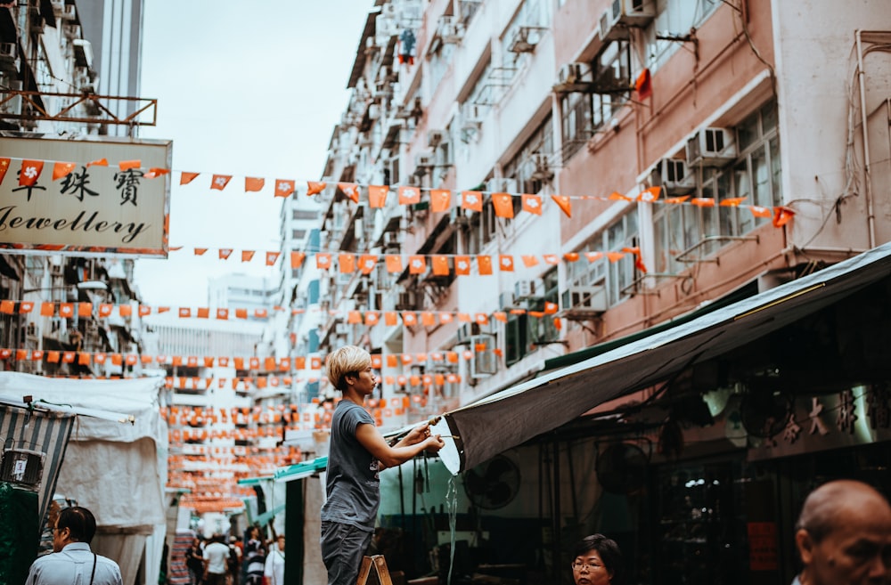 people on road beside buildings