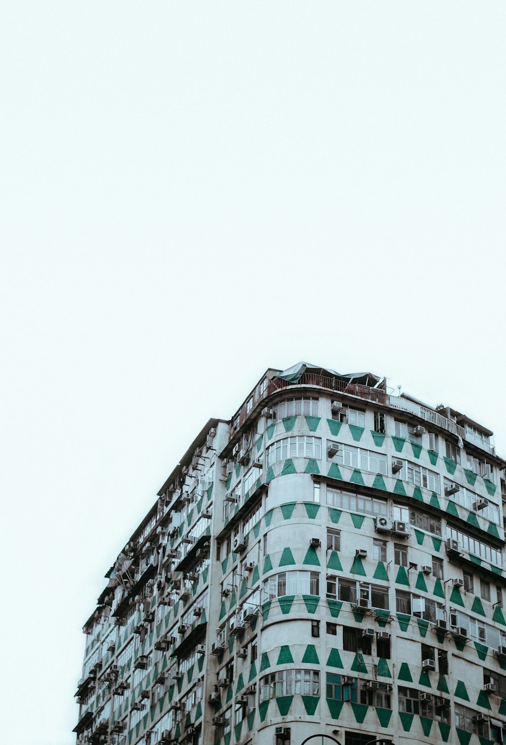 low-angle photography of white and green concrete building at daytime