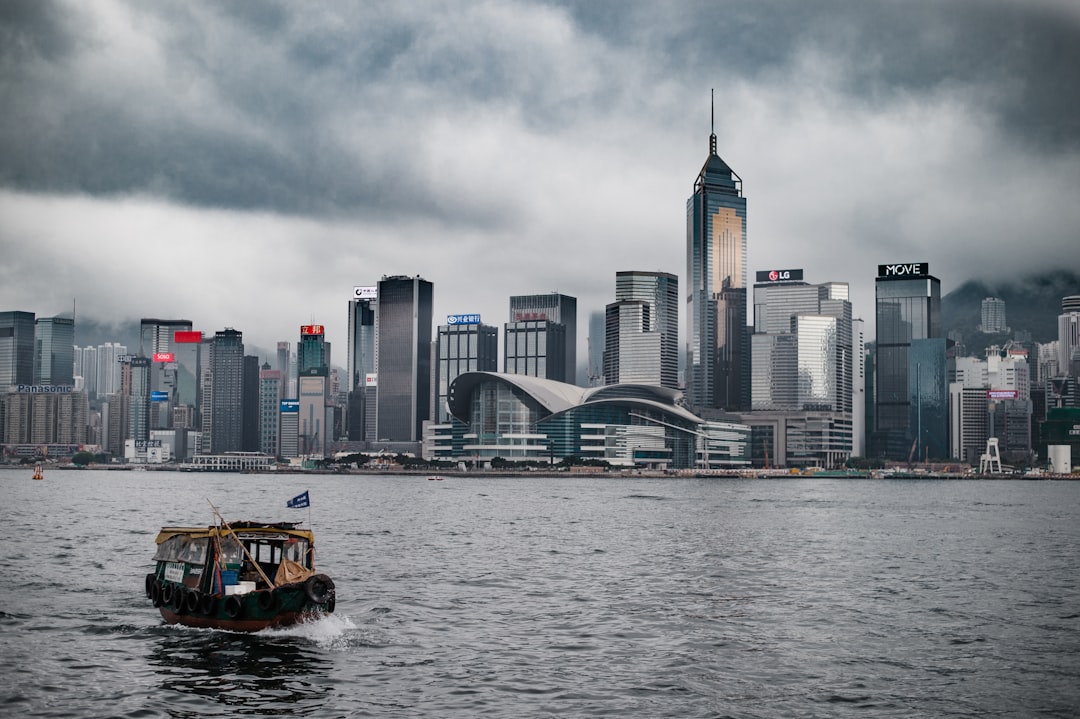 brown boat near city with high-rise buildings