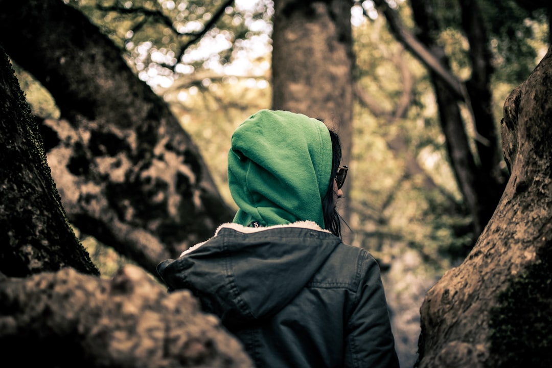 woman standing under tree during daytime