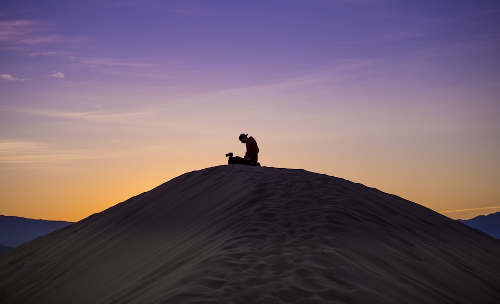 silhouette of man and woman on desert