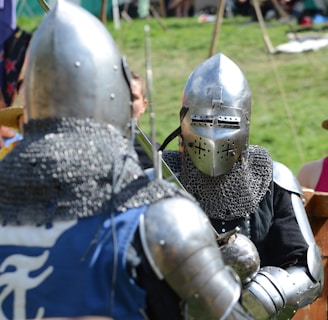 two men wearing silver knight armor facing each other