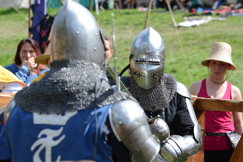 two men wearing silver knight armor facing each other