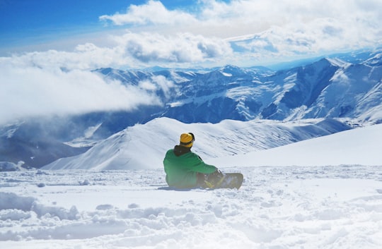 man snowboarding on snow during daytime in Gudauri Georgia