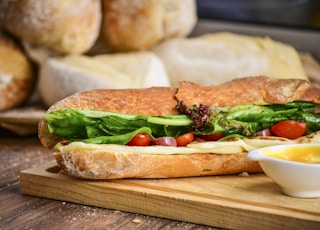 baked bread with vegetable on brown chopping board