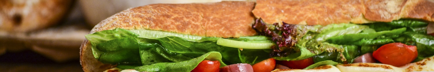 baked bread with vegetable on brown chopping board