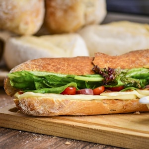 baked bread with vegetable on brown chopping board